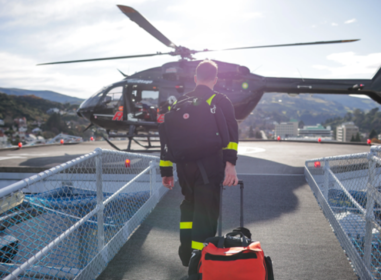 Michael, Critical Care flight nurse walking towards a helicopter.